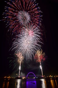 Low angle view of firework display at night