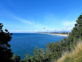Scenic view of sea against blue sky