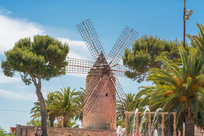 Low angle view of traditional windmill against sky