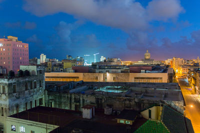 View of cityscape against cloudy sky