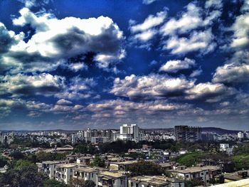 Cityscape against cloudy sky