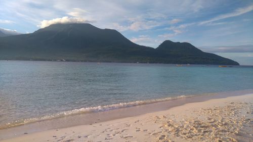 Scenic view of sea against cloudy sky