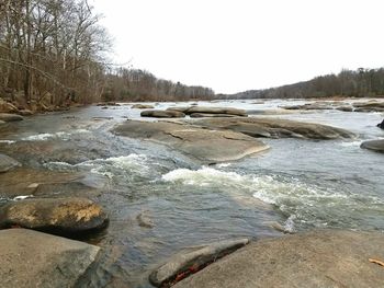 Scenic view of river against clear sky during winter