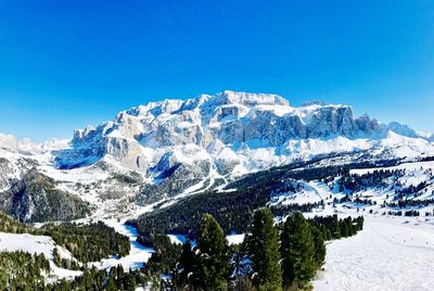 Scenic view of snowcapped mountains against clear blue sky