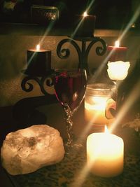 Close-up of illuminated tea light candles on table