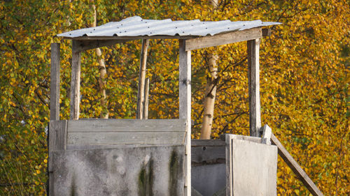 Wooden fence on field during autumn