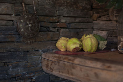 Close-up of fruits on table against wall