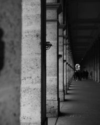 Rear view of man walking on corridor of building