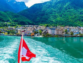 Swiss flag against river in town