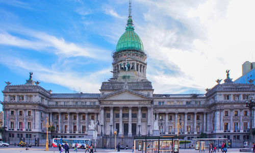 Group of people in front of building against sky