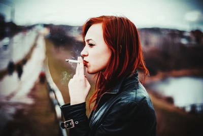 Young woman smoking cigarette