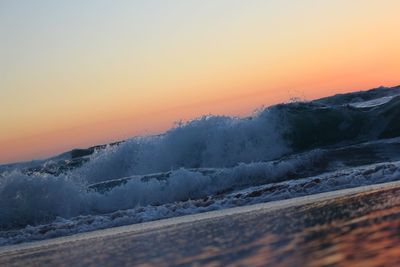 Scenic view of sea against clear sky during sunset