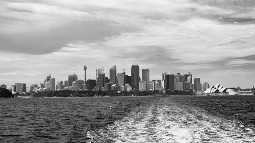 Modern buildings by sea against sky