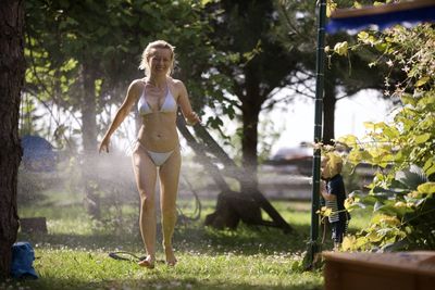 Full length of young woman standing in park