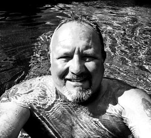 Portrait of man smiling in swimming pool
