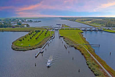 High angle view of river amidst land against sky