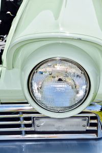 Reflection of woman on side-view mirror of car