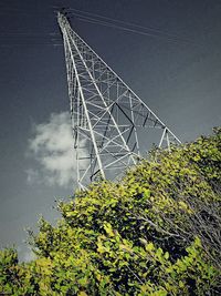 Low angle view of electricity pylon against sky