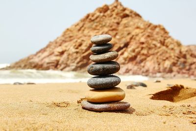 Stones stacked on shore at beach