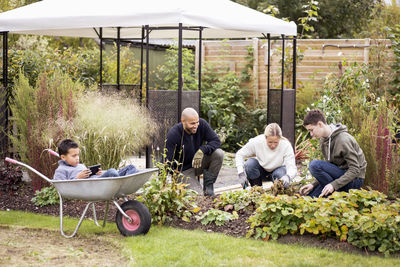 Multiethnic family gardening at yard