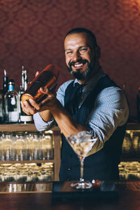 Portrait of a smiling man with drink