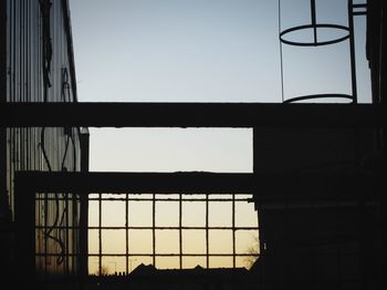 Low angle view of silhouette built structure against clear sky