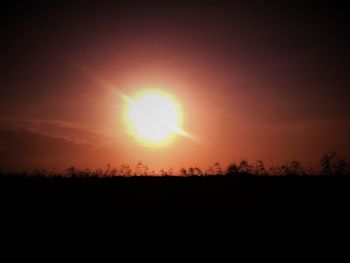 Scenic view of silhouette field against sky during sunset