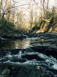 Close-up of water flowing against sky