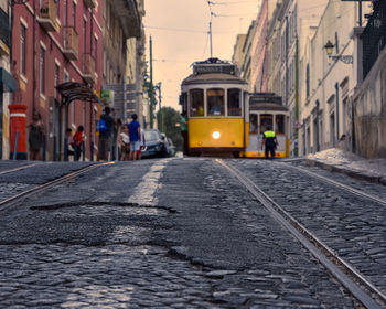 Travel concept of lisbon's famous trams. focusing on the cobbled streets with the trams 