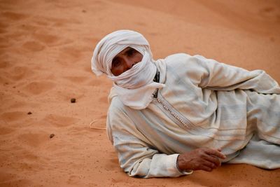 Portrait of man sitting on sand