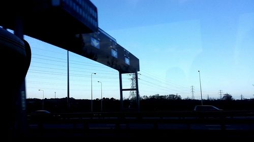 Cars on road against clear sky