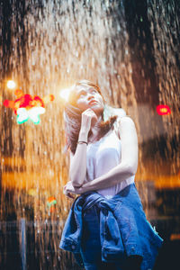 Young woman looking at camera during rainy season