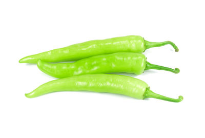 Close-up of green chili pepper against white background