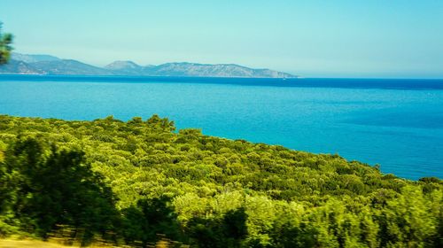 Scenic view of sea with mountains in background