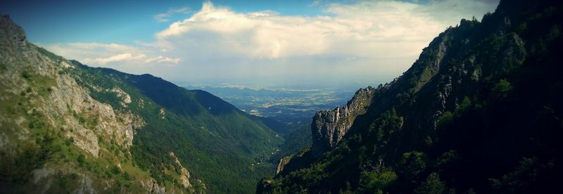 Scenic view of mountains against cloudy sky