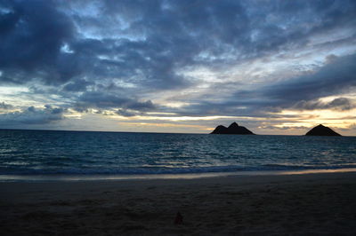 View of beach against cloudy sky
