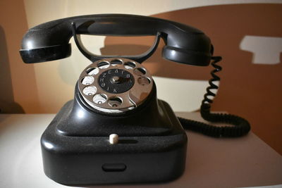 Close-up of telephone on table