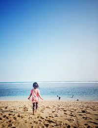 Scenic view of beach against blue sky