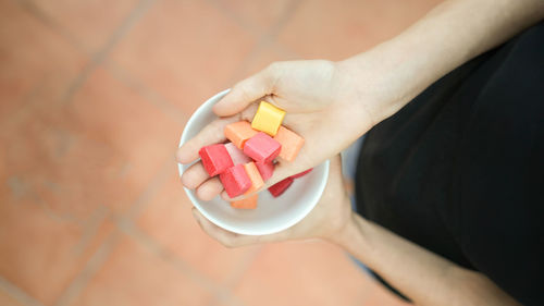 Midsection of woman holding pills