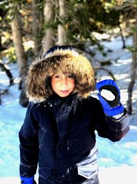 Portrait of boy standing on snow