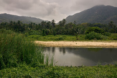 Scenic view of lake and mountains against sky