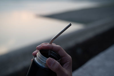 Close-up of hand holding cigarette