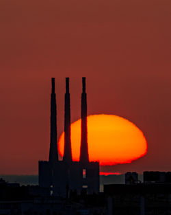 Silhouette of 3 chimneys at sunrise. sant adrià de besòs, barcelona.