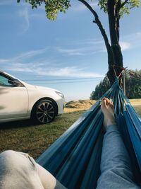 Low section of man relaxing on hammock