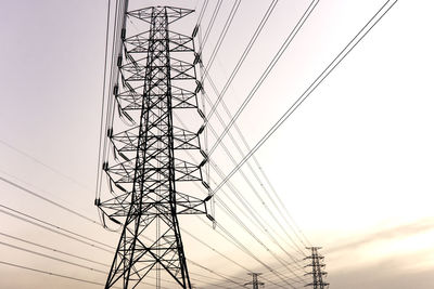 Low angle view of electricity pylon against sky