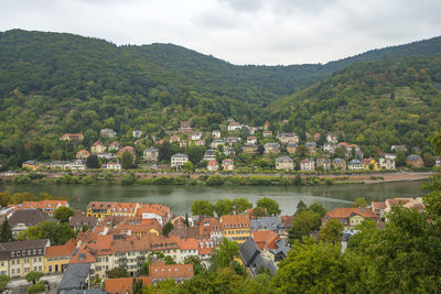 High angle view of townscape by mountain against sky