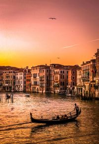 Buildings in city at sunset