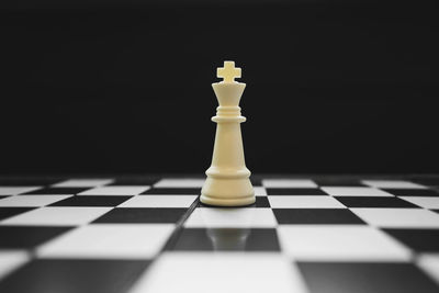 Close-up of chess pieces against black background