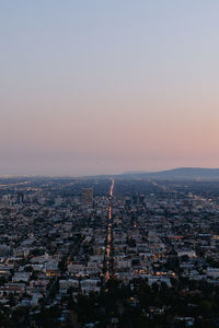 Aerial view of city buildings during sunset