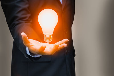 Close-up of hand holding light bulb